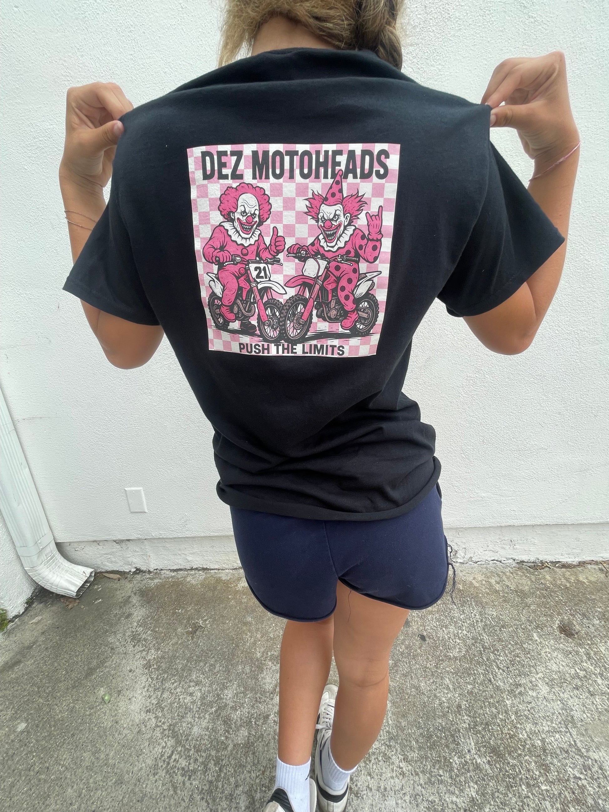 Pink/white checkered dirt bike riding clowns